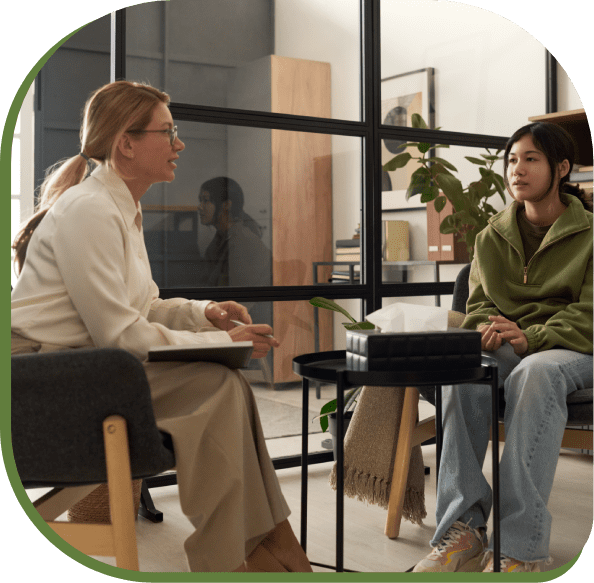 Two women engaged in a serious conversation in a modern office.